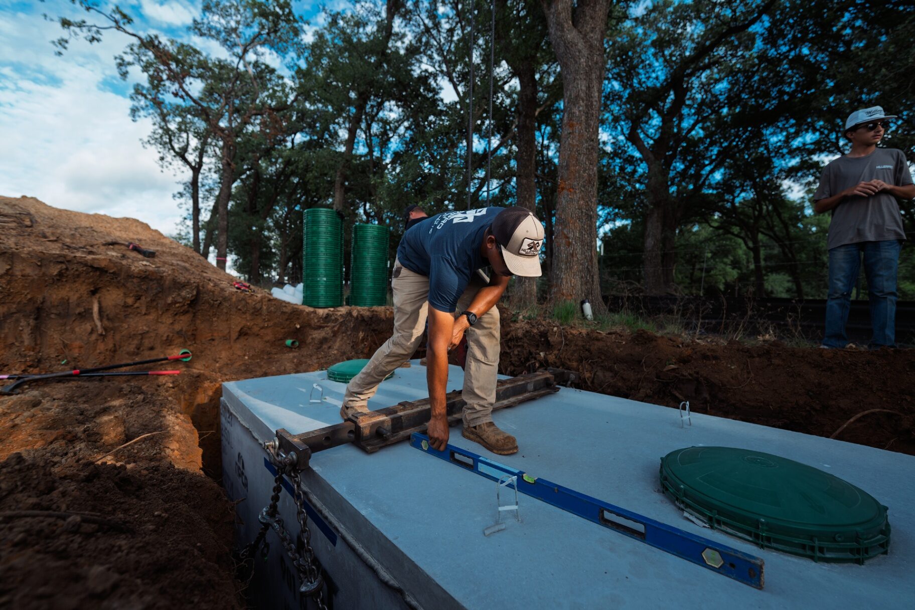 MillerPro crew leveling a commercial concrete septic tank at a Texas job site